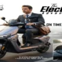 Business professional commuting on an EV Sports electric scooter with digital display and modern urban mobility theme.